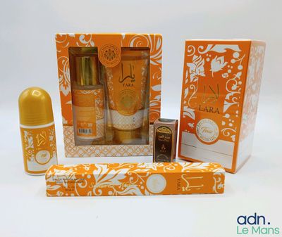 an orange and white box containing a bottle of perfume and a tube of lip bale