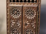 an old wooden cabinet with ornate carvings on the doors