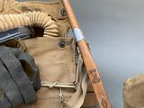 a pair of gloves, a hat, and a baseball bat on a table