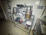an image of a kitchen with pots and pans on a rack