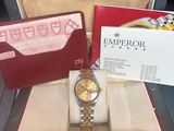 a box with a watch and a card in it on a table