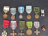 an assortment of medals and medals are displayed on a table