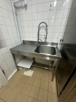une cuisine avec un évier et un réfrigérateur