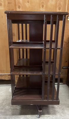 a wooden bookcase with three shelves on it in a room
