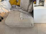a couch with a blanket on it in a living room