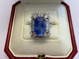 an image of a blue sapphire and diamond ring in a red box