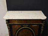 a marble top cabinet with a black and gold trim
