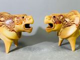 deux figurines de lions exposées sur une table