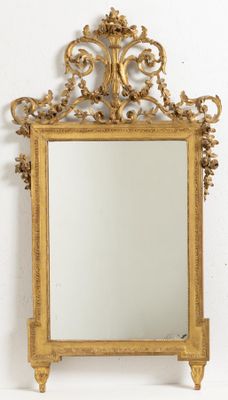 an image of a gold framed mirror on a white wall