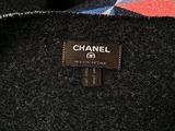 a close up of a chanel label on a black coat