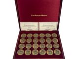 a red box with twelve gold coins in it on a white background