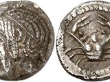 a silver coin with an image of a woman and a man on it