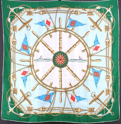 an image of a green and white square scarf with nautical flags