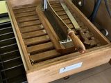 a wooden box with a knife and a pair of knives in it