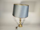 a lamp that is sitting on a table with a blue shade on it