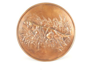 a bronze coin with a bird on it on a white surface