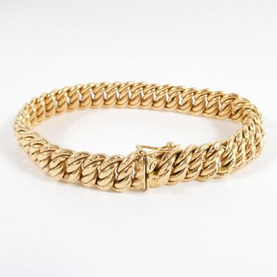 a yellow gold bracelet with a braid design