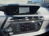 the dashboard of a car with a view of a parking lot in the background