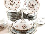 a lot of plates and bowls sitting on a table