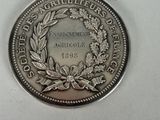a close up of a coin on a table with a white background