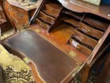 a wooden desk with a mirror on top of it