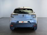 the rear end of a blue car in a white room