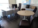 a table and chairs in a room with a map on the wall