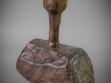 sculpture of a wooden mallet with a wooden handle on a gray background