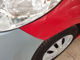 a close up of a red and blue car ' s headlight