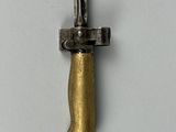 a close up of a knife on a white surface