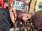 a tractor that is parked on the side of the road