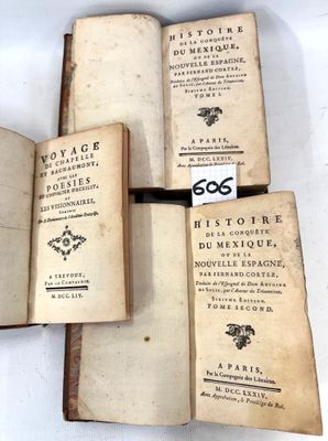 several old books are stacked on top of each other on a table