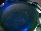 a close up of a blue glass bottle on a table