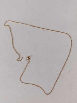 a gold necklace with a chain that has been cut in half