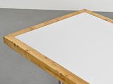 the table is made of wood and has a white top