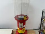 a red and yellow machine sitting on a tiled floor