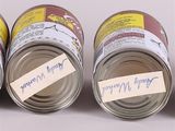 three cans of canned food with labels on them sitting next to each other