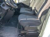 the interior of a van with the door open and the driver ' s seat down