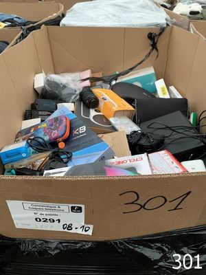 a cardboard box full of electronics and other items