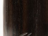 a close up of a wooden vase on a white surface