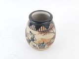 a small vase with a painting on it on a white surface