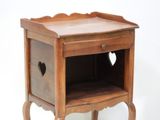 a small wooden table with a heart on it