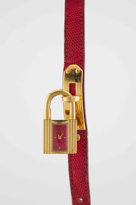 a close up of a red watch with a lock on it