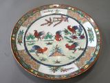 a plate with a picture of roosters and trees on it