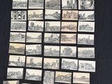 a lot of old postcards on the table