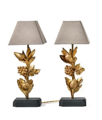 a pair of gold leaf lamps with shades on a white background
