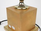 brass plated table lamp with a glass globe on a wooden base