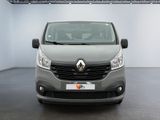 the front view of a grey van parked in a showroom