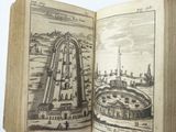 an open book with a picture of a city in it
