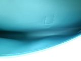 a blue purse that is sitting on a table